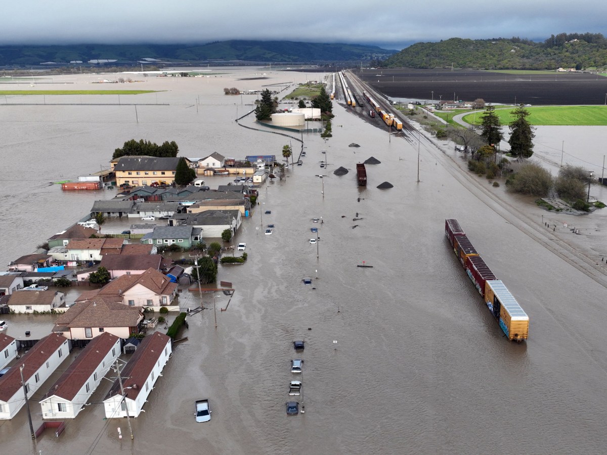 Trains, cars, vehicles, homes and farmland are engulfed by floodwaters in Pajaro, California, on March 11th after a levee burst on the Pajaro River.