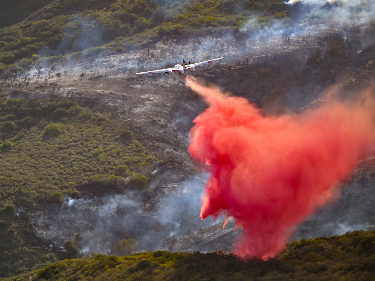 Firefighters drop retardant over Aliso Canyon during the Coastal Fire in Laguna Niguel, California, on May 11, 2022.