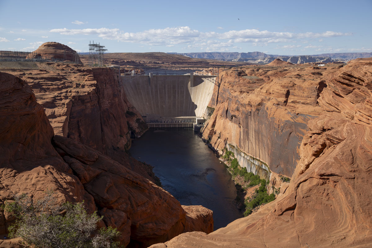The Glen Canyon Dam sits on the Colorado River, backed by Lake Powell. In 2022, the dam neared deadpool conditions due  to climate change-induced drought and increasing water demand.