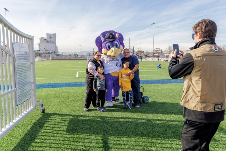 Angel Velasquez, left, and her husband, Delbert Velasquez, and their children, Delyana and DJ, pose for a photo with the Colorado Rockies mascot at the new park built over Interstate 70 in Denver’s Globeville Elyria-Swansea neighborhood. 