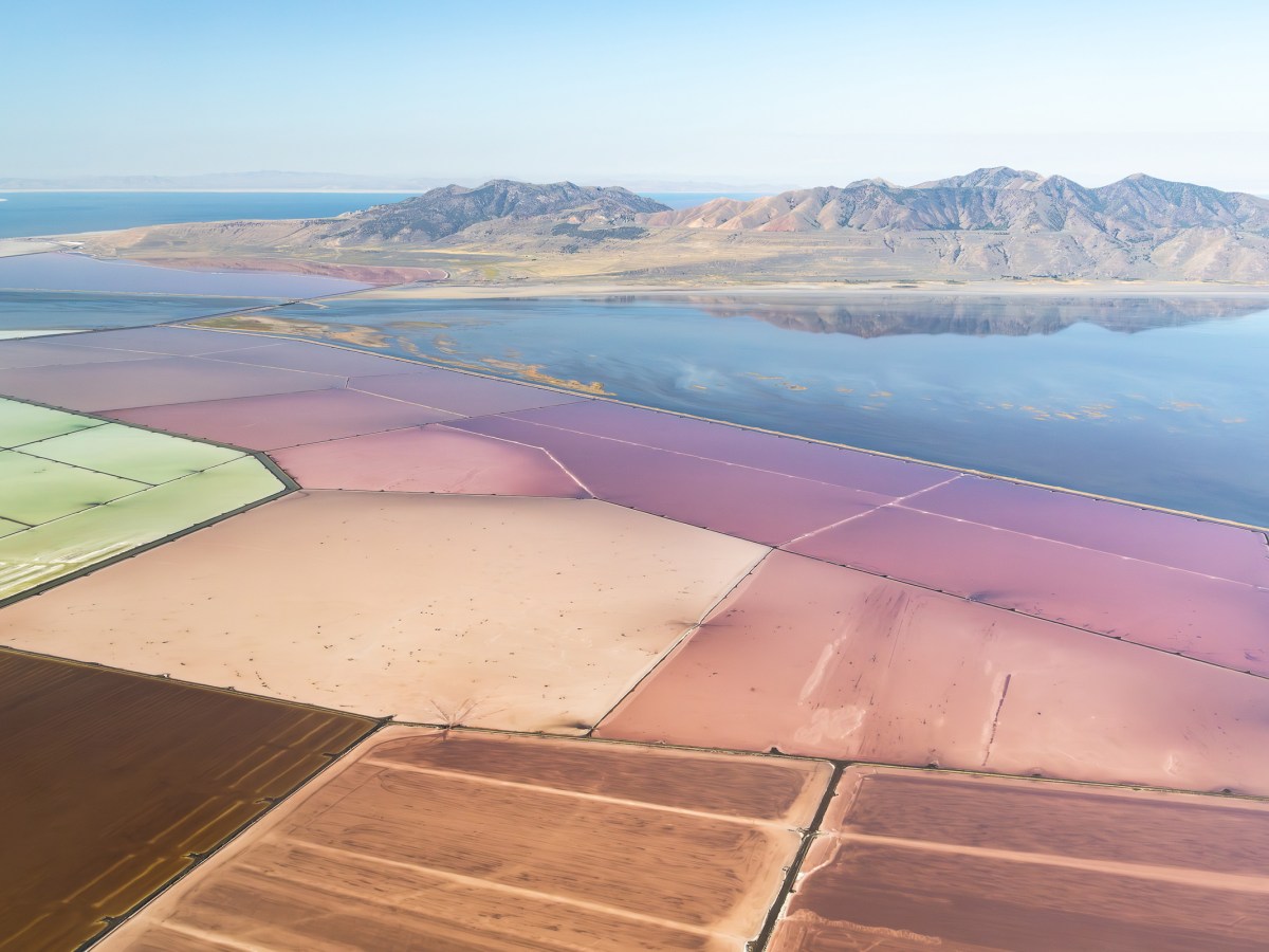 A view of Compass Minerals evaporation ponds looking toward the Promontory Mountains where the Bear River feeds into the Great Salt Lake. Due to a record snowpack this year, there is water passing through this area. In 2022, the Bear River dried up before reaching the Great Salt Lake.