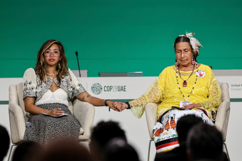 Mitzi Jonelle Tan, co-founder of Youth Advocates for Climate Justice, and Casey Camp-Horimek, Ponca Nation environmental ambassador and WECAN board member, speak at a panel on climate justice strategies and solutions at the COP28 annual conference in Dubai, United Arab Emirates.