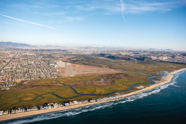 An aerial view shows the sprawling development that surrounds the Tijuana Estuary. Imperial Beach and a naval  landing field are on the left, while Tijuana, Mexico, lies just beyond  the reserve on the right side of the image. (Aerial support provided  by LightHawk)