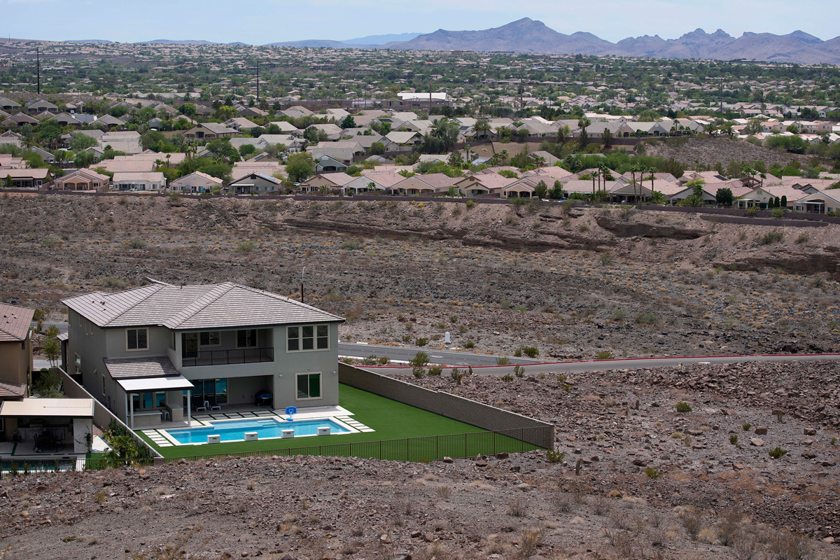 A home with a swimming pool abuts the desert on the edge of the Las Vegas valley on July 20, 2022, in Henderson, Nevada.