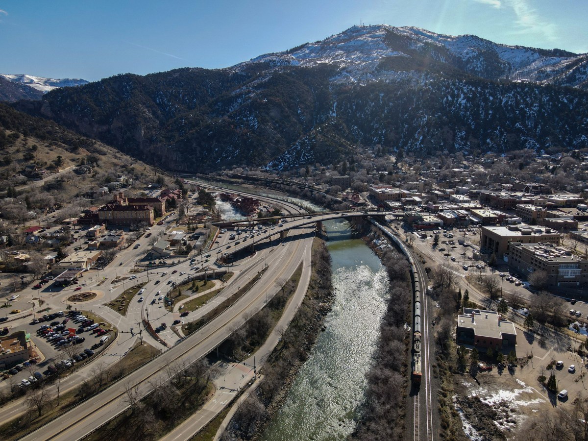 A BNSF Railway train travels east along the Colorado River in Glenwood Springs, Colorado, on its way toward Denver, following the same route proposed for the Uinta Basin Railway project.