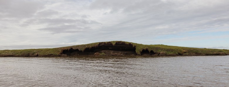 A tundra island near Kasigluk erodes, exposing thawing permafrost. Two months after this photo was taken, the opening collapsed completely.