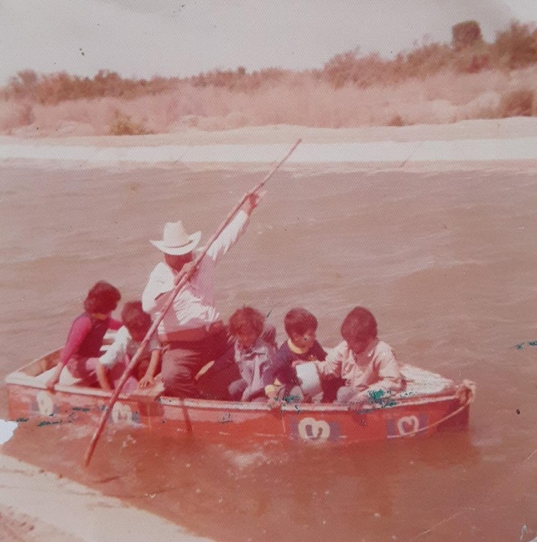 Grandfather and children in canal, circa 1970.