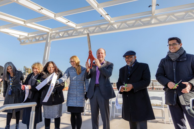 Colorado Gov. Jared Polis and then-Mayor Michael Hancock, center, along with other officials, gather at the ribbon-cutting ceremony for the cover park on Nov. 30, 2022.