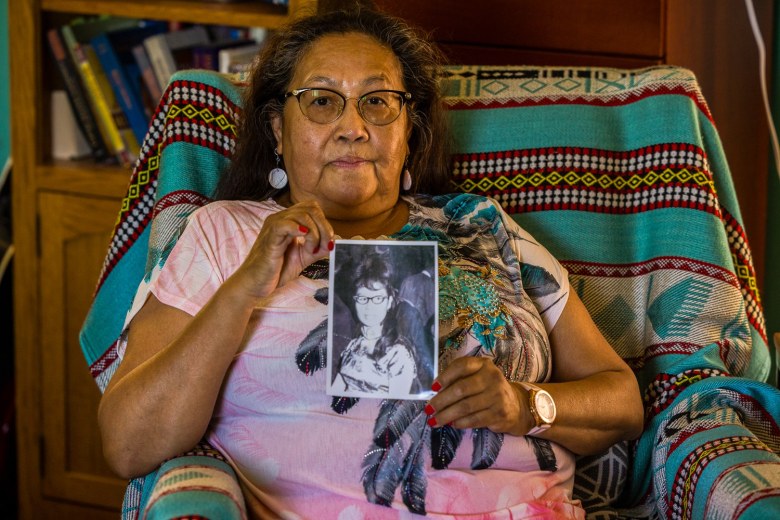 Violet Soosay holds a photo of her aunt, Shirley Soosay.