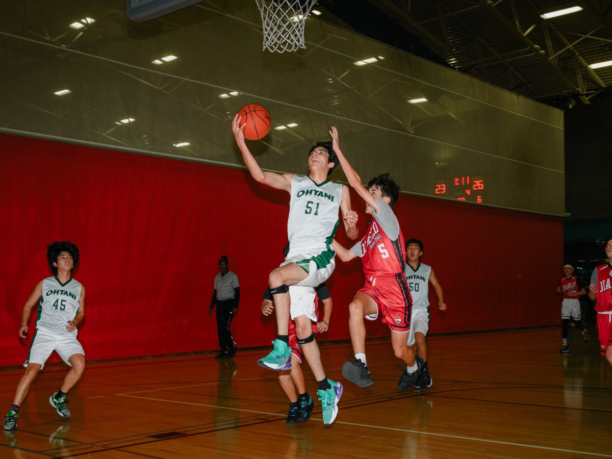 Parker Nomura, one of Kai’s teammates, goes in for a layup during a game against Diablo, a rival program, at Tice Valley Community Center in Walnut Creek, California.