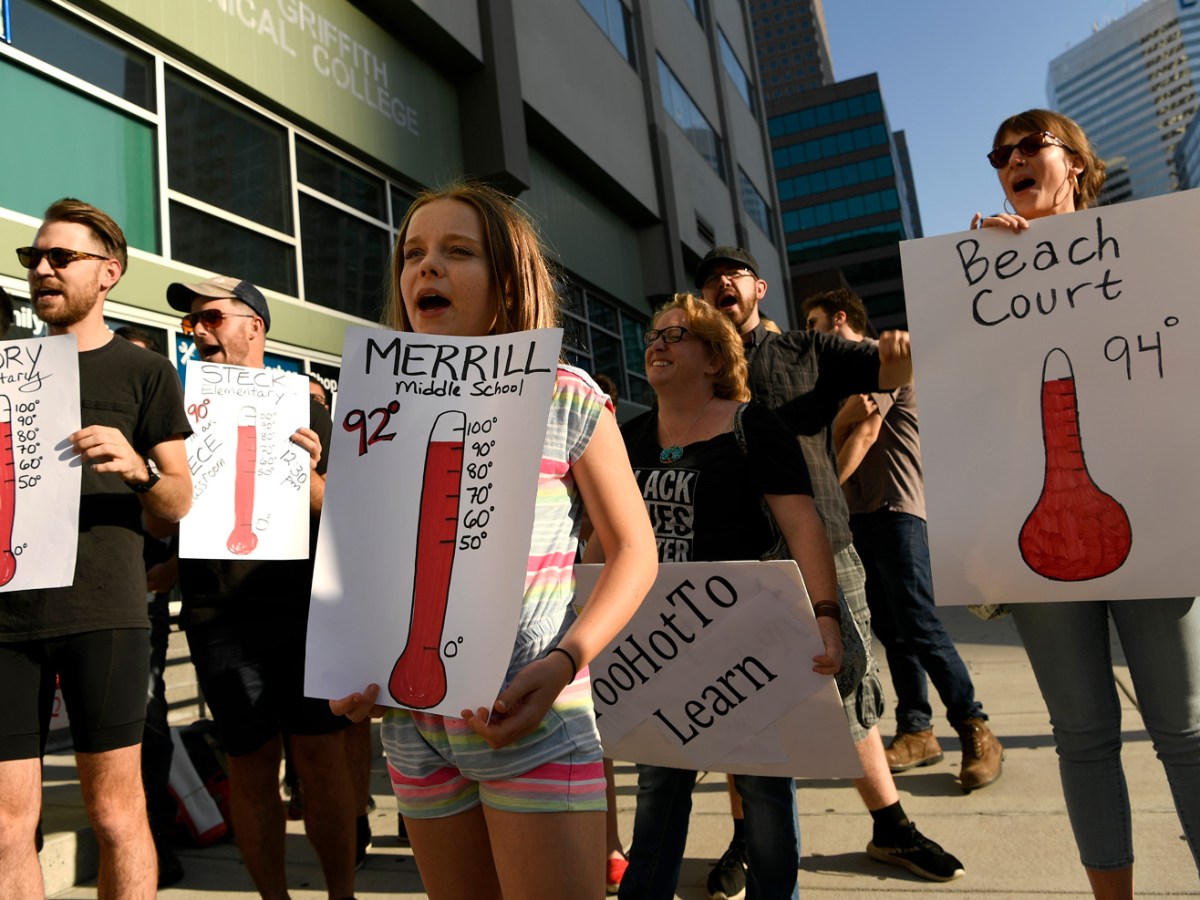 Elise Myren, a 7th grade student, joins teachers and community supporters in protest outside of the Denver Public Schools administration building to demand equity for students attending classes in excessively hot classrooms in Denver, Colorado, on August 26, 2019.