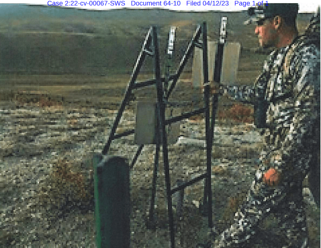 Zach Smith holds the ladder used to surmount fence posts to reach public land adjacent to Elk Mountain Ranch in this exhibit filed in the trespassing lawsuit.